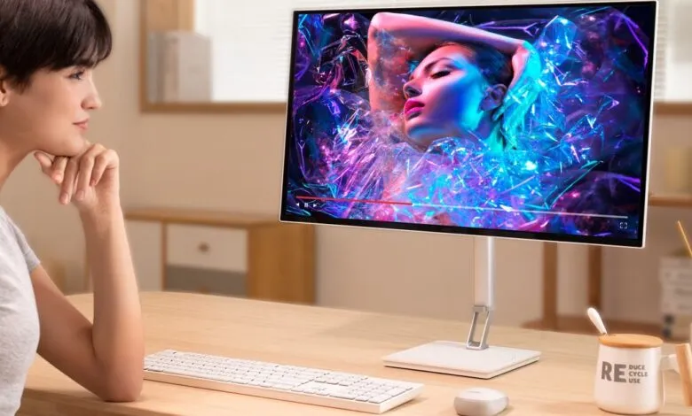 Woman watches vibrant video on Acer monitor.