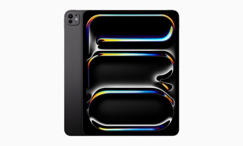 A dark gray Apple iPad Pro with a colorful, abstract wallpaper displayed on its screen.