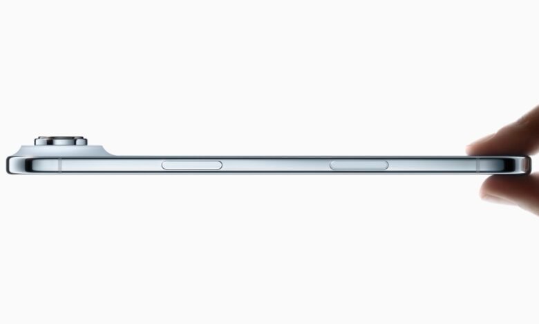 Side profile of a silver iPhone, showcasing its sleek design and camera bump.