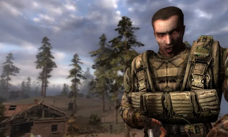 Close-up of a weathered soldier in tactical gear, with a ruined building and forest in the background.