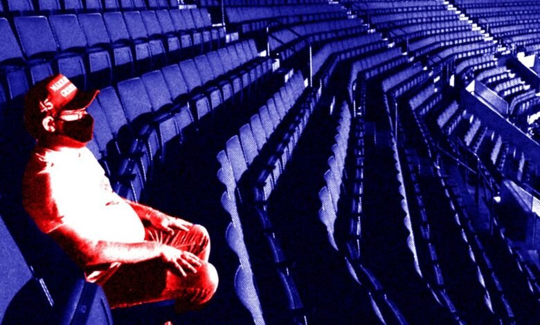 A person wearing a red hat with 'MAGA' and '45' sits in empty stadium seats.