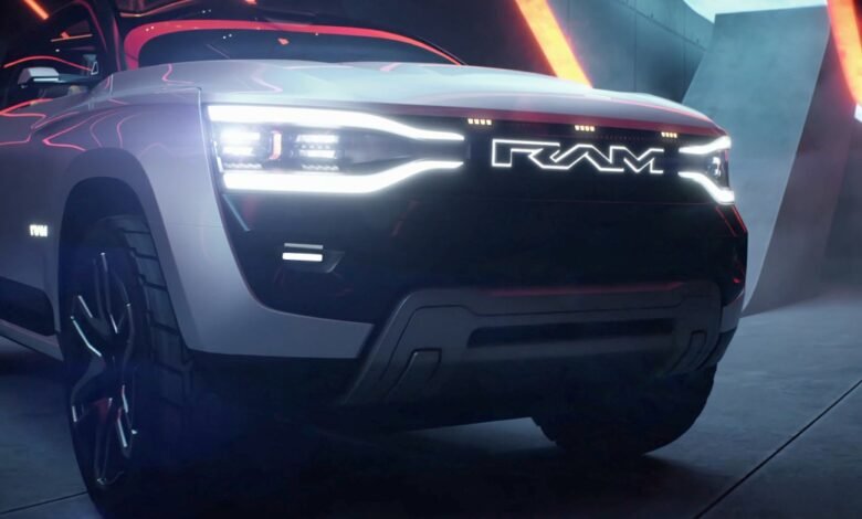 Close-up of a sleek, white Ram electric pickup truck, showcasing its illuminated headlights and logo against a dark, futuristic backdrop.