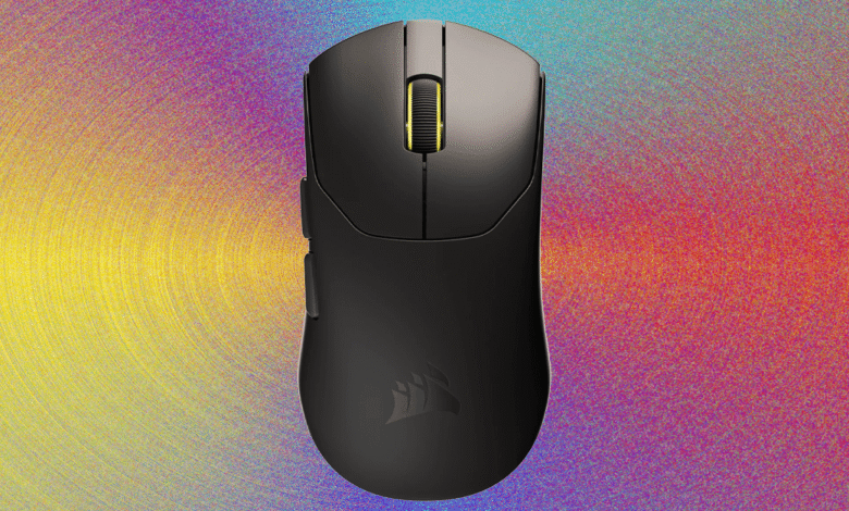 Black wireless gaming mouse with yellow scroll wheel on a colorful gradient background.