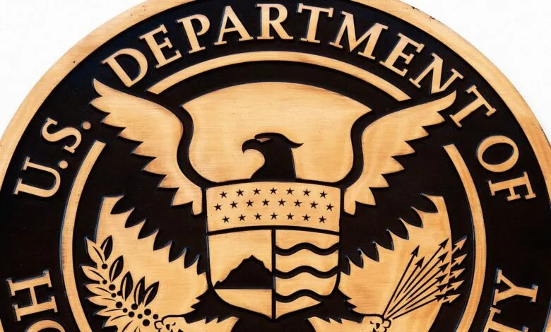 Close-up of the Department of Homeland Security seal, featuring an eagle and shield.