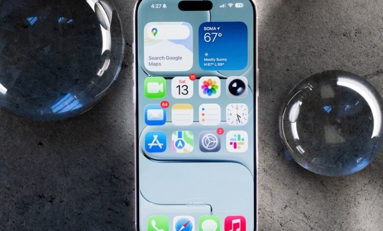 iPhone mockup showcasing iOS interface with weather, maps, and various apps displayed on the screen, surrounded by glass spheres on a dark surface.