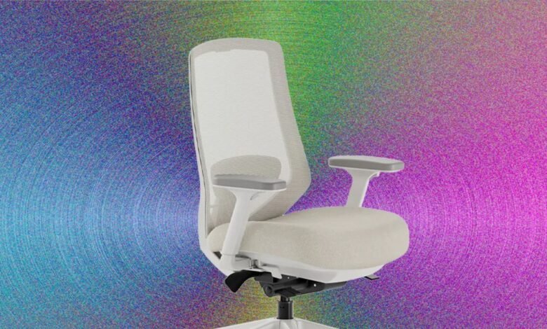 Modern white office chair with mesh back and adjustable arms, shown against a colorful abstract background.