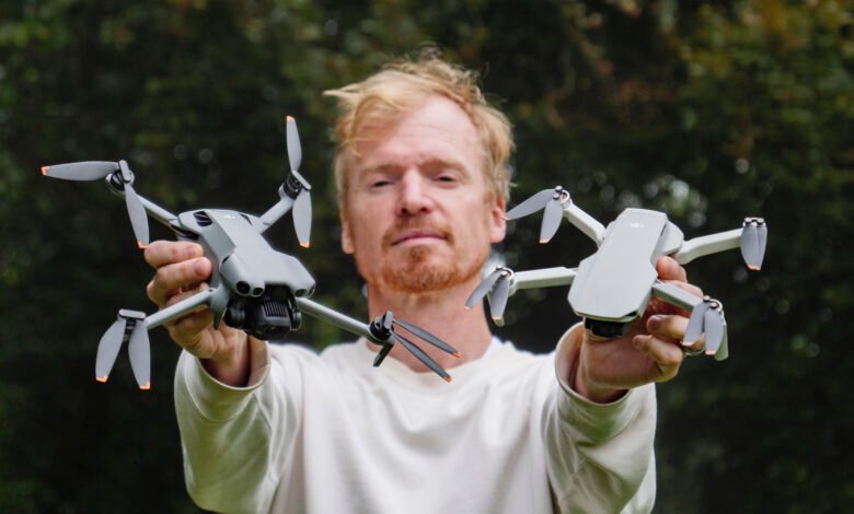 Man holding DJI Mini 3 Pro and DJI Mini 2 drones. A comparison of drone models.
