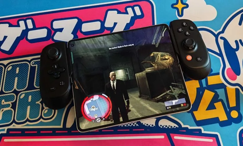 Agent 47 in Hitman game on tablet with controllers.