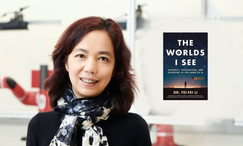 Dr. Fei-Fei Li, Stanford professor, smiles warmly beside her book, 'The Worlds I See,' about AI.
