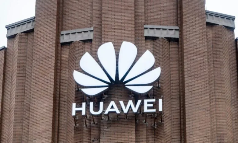 Huawei logo on a brick building. The logo is white and features a stylized flower.
