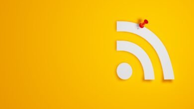 RSS feed symbol with a red pushpin on a yellow background.