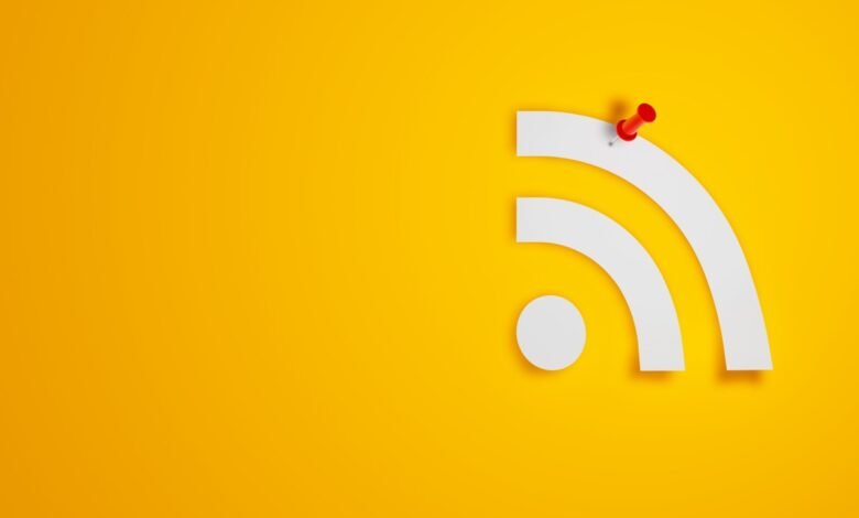 RSS feed symbol with a red pushpin on a yellow background.