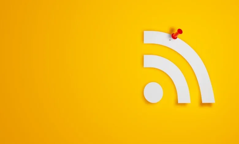 RSS feed symbol with a red pushpin on a yellow background.