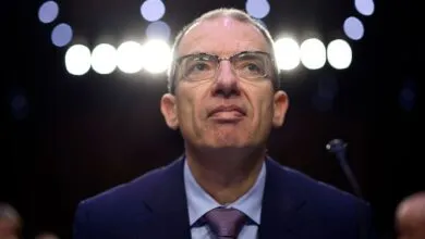 Close-up portrait of Jerome Powell, Chairman of the Federal Reserve, looking upward.