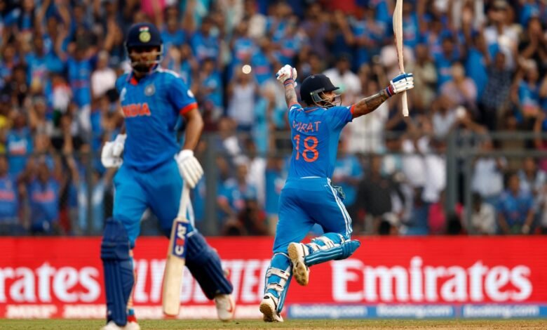 Virat Kohli, Indian cricketer, celebrates a shot during a match, raising his bat in triumph.