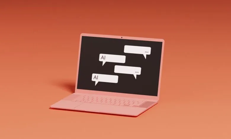 Pink laptop displaying AI chat bubbles on a coral background.