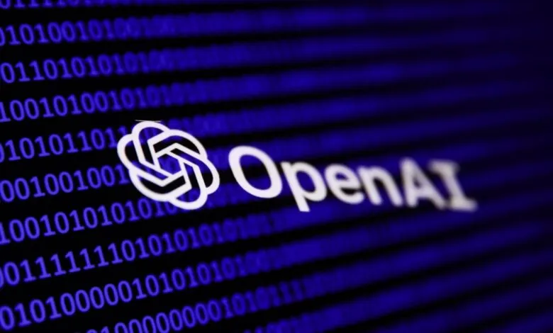 Close-up of the OpenAI logo displayed on a screen showing binary code. The logo is white against a dark blue background.