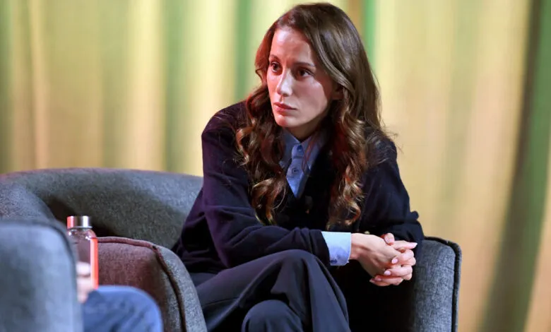 Mira Murati, OpenAI's CTO, sits in a chair during an interview, looking thoughtfully off-camera.