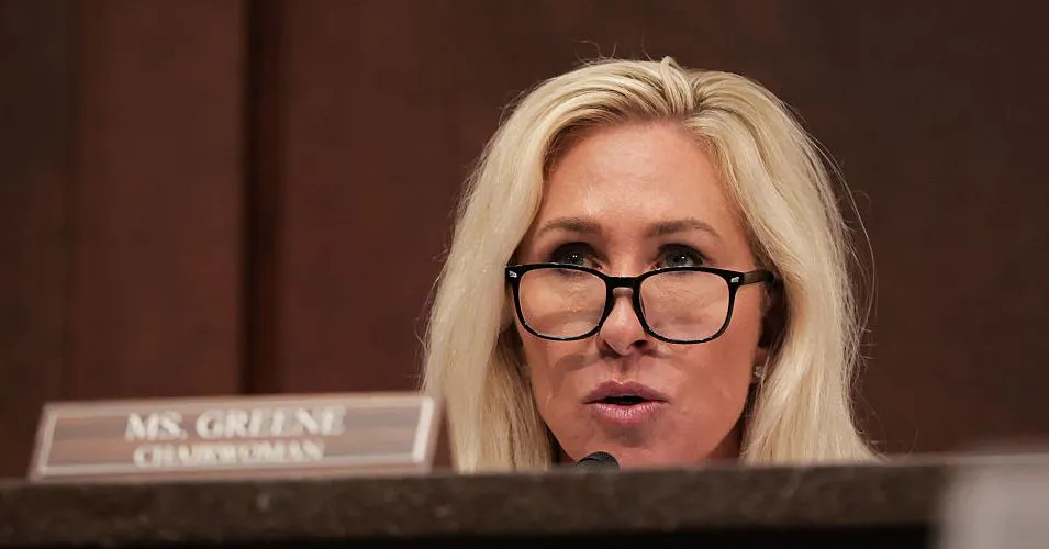 Close-up of Rep. Marjorie Taylor Greene, wearing glasses, speaking at a hearing.