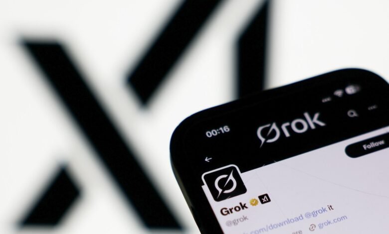 Close-up of a smartphone displaying the Grok app and Twitter profile, featuring the Grok logo and account details against a blurred background.