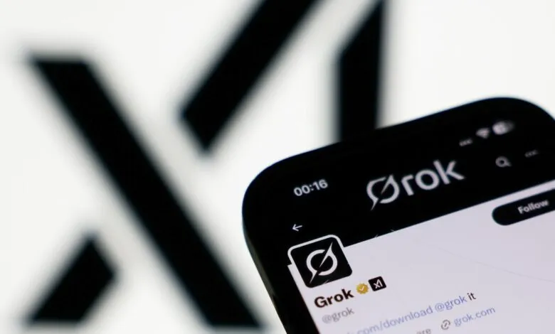 Close-up of a smartphone displaying the Grok app and Twitter profile, featuring the Grok logo and handle.