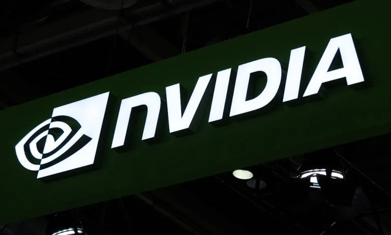 NVIDIA logo illuminated on a dark green sign at a tech event.