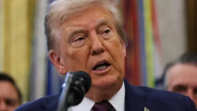 Close-up of President Donald Trump speaking at a podium in the Oval Office.