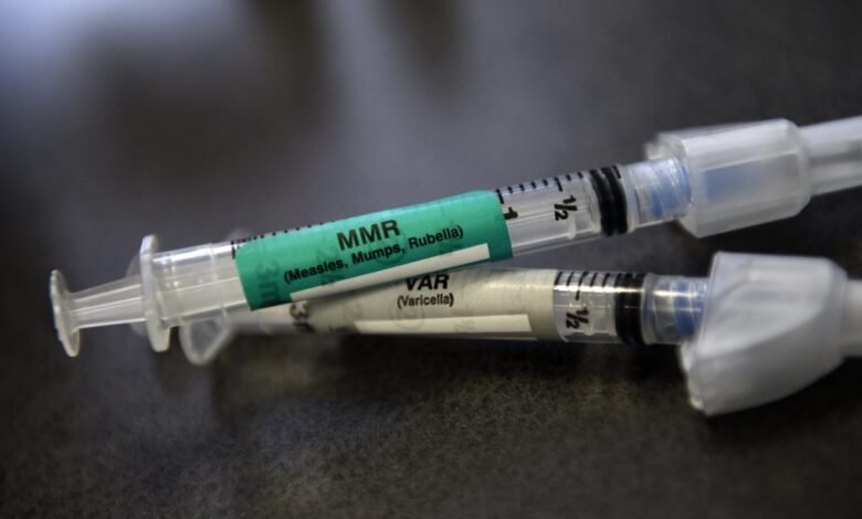Close-up of MMR and Varicella vaccine syringes.