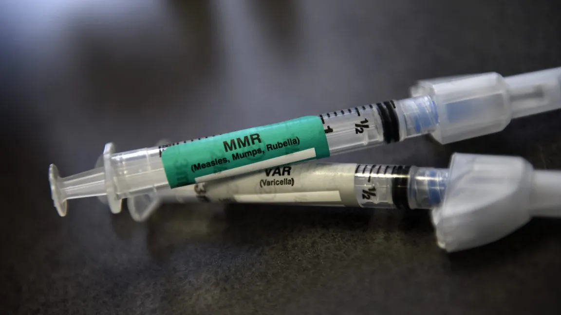 Close-up of MMR and Varicella vaccine syringes.