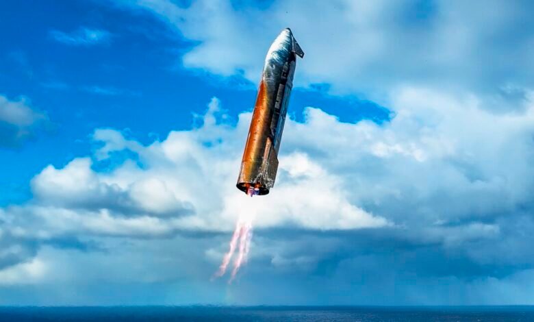 Rocket booster descending through a cloudy sky, flames visible from its engine.