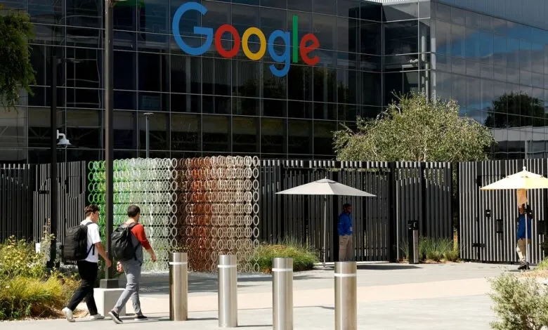 Google headquarters exterior shot showing the building's logo and employees walking by.