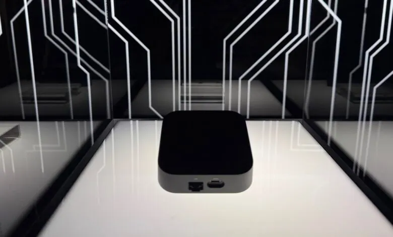 Black rectangular device on display, featuring ports and a minimalist design.