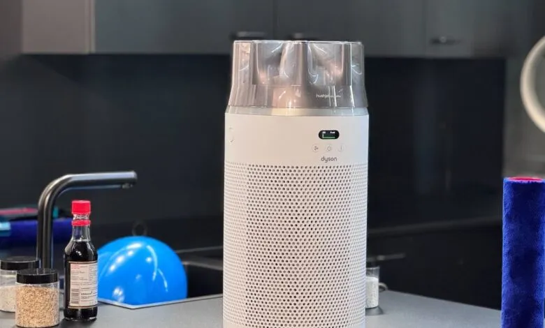 Dyson air purifier on kitchen counter, off-white with silver top, in modern kitchen setting.