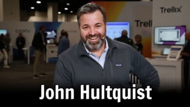 John Hultquist smiles at the camera in a conference setting with Trellix branding.