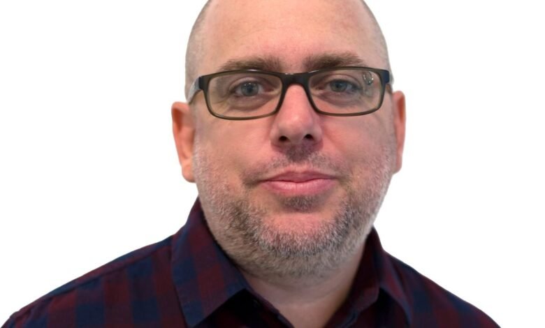 Headshot of Marc Maiffret, CTO of BeyondTrust, wearing glasses and a burgundy and navy plaid shirt.