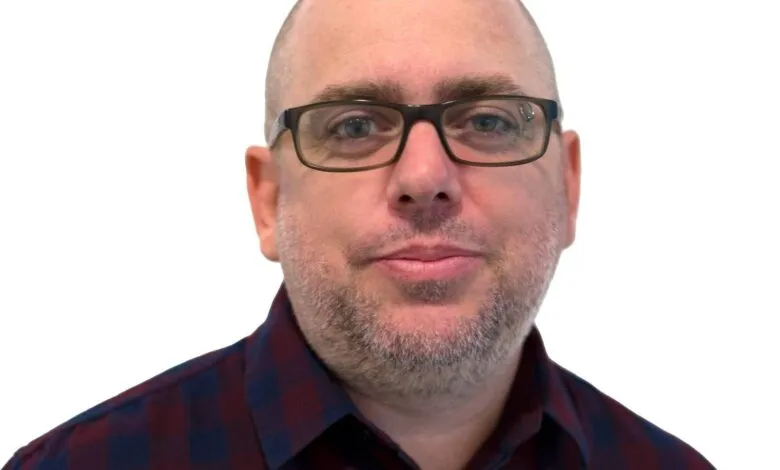 Headshot of Marc Maiffret, CTO of BeyondTrust, wearing glasses and a burgundy and navy plaid shirt.