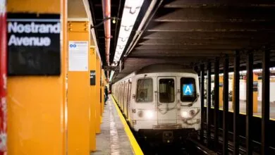 NYC subway train arriving at Nostrand Avenue station. A train pulls into the platform.