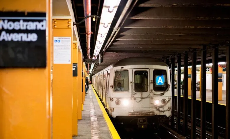 NYC subway train arriving at Nostrand Avenue station. A train pulls into the platform.