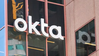 Close-up of the white Okta logo on a modern building facade.