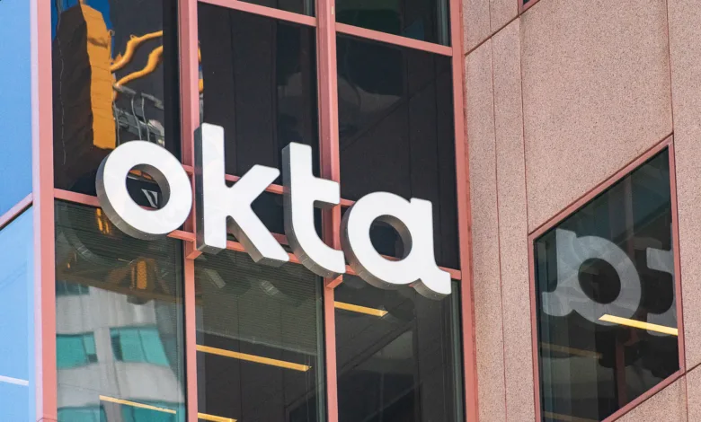 Close-up of the white Okta logo on a modern building facade.