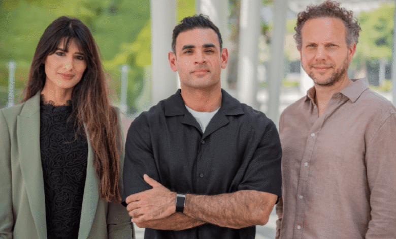 Three founders of Orbii Seed pose for a professional headshot, with a woman in a green blazer on the left and two men in casual shirts on the right.