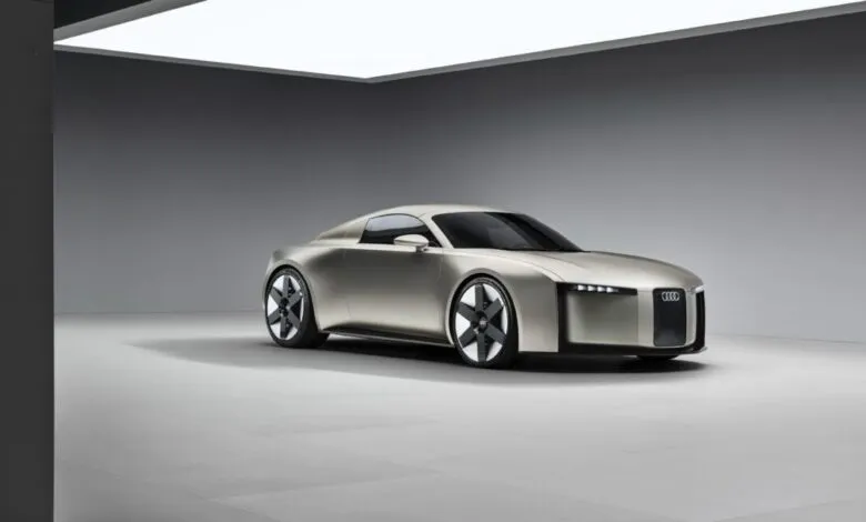 Sleek, silver Audi Concept C electric car in a minimalist studio setting.