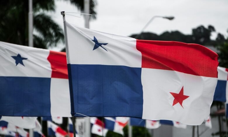 Several Panamanian flags waving in the wind, showcasing the blue, white, and red colors and a prominent star.