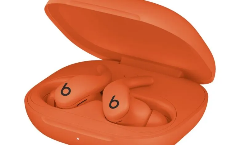 Orange Beats Fit Pro earbuds in their charging case.