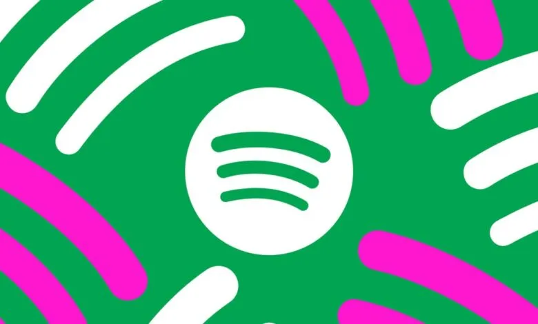 Spotify logo on a green background with pink and white abstract shapes.