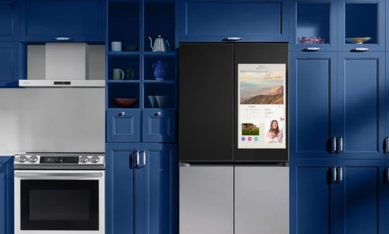 Samsung Bespoke Family Hub refrigerator with touchscreen in a navy blue kitchen.