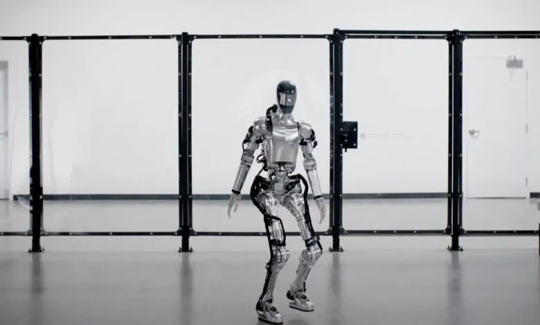 Humanoid robot in a testing facility, taking a step. Silver metallic body, detailed mechanics visible.