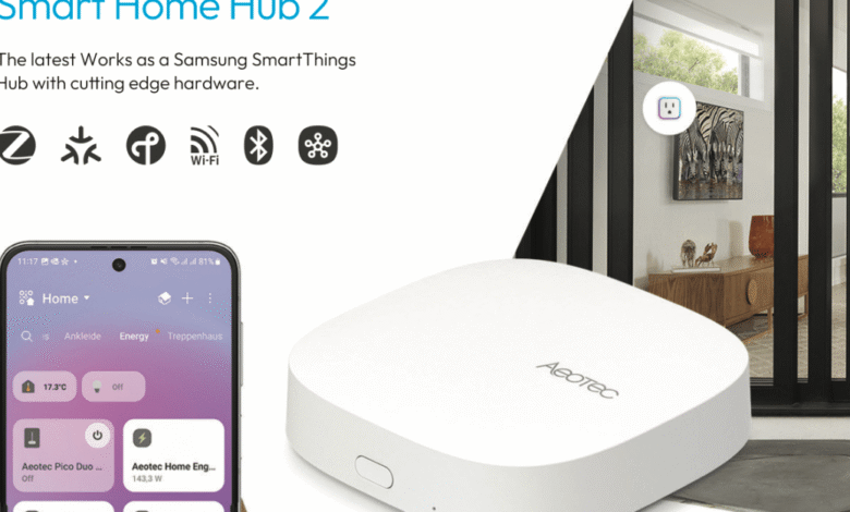 White Aeotec Smart Home Hub 2, compatible with Samsung SmartThings, shown with smartphone app interface.