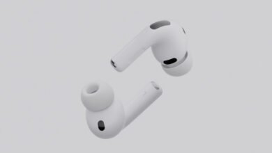 Pair of white Apple AirPods Pro shown from different angles against a light gray background.