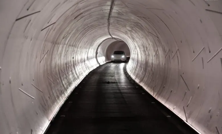 White Tesla driving through The Boring Company's tunnel.
